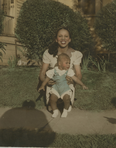 Bessie holding Lee Harris in front of his childhood home in Hackensack, New Jersey