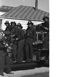 Group of Oakland firefighters standing on fire engine