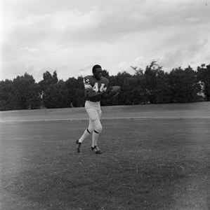 Football player running with the ball, 31