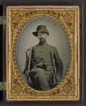 [Unidentified soldier in Union cavalry uniform with cavalry sword, Colt Army revolver, and carbine]