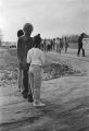 Woman and children watching the 20th anniversary reenactment of the Selma to Montgomery March in rural Dallas or Lowndes County, Alabama.