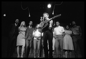 Bob Dylan leading performers on stage, Newport Folk Festival Left to right: Peter Yarrow, Mary Travers, Paul Stookey, Joan Baez, Bob Dylan, Bernice Reagon, Cordell Reagon, Charles Neblett, Rutha Harris, Pete Seeger