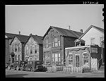 [Untitled photo, possibly related to: Houses and grocery store on Federal Street in the Negro section of Chicago, Illiniois]