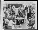 [Dr. Martin Luther King (left) and Fred L. Shuttlesworth seated at table and surrounded by newsmen at a news conference, Birmingham, Alabama]