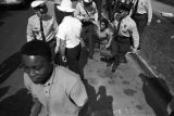 Police officers arresting a civil rights demonstrator during the Children's Crusade in Birmingham, Alabama.