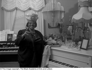 Photograph of gospel singer Francine Morrison posing with her awards