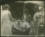 White woman and 2 African-American boys stringing tobacco near Marion, S.C.