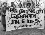 Women display a banner advertising a Martin luther King Day celebration at the Frankford-Northeast YWCA