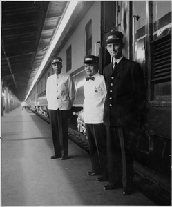 Pullman porters and conductor on train platform: photoprint