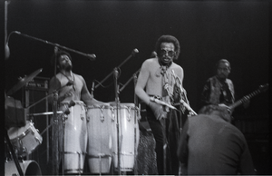 Miles Davis in performance: James Mtume (congas), Miles Davis (trumpet), and Khalil Balakrishna (electric sitar)