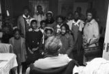 Children in the group "Buds of Promise" from Mt. Zion AME Zion Church in Montgomery, Alabama, singing to Ethel Reynolds in her home.