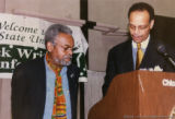 Amiri Baraka and Haki Madhubuti at a podium