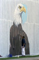 Lorenzo Green painting a bald eagle for a patriotic mural on the side of Lambert's Cafe on Highway 59 in Foley, Alabama.