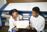 Eight-year-old Monica Bland talking with Rhonda Freeman - Baraka, an editor of the Tuskegee News in Tuskegee, Alabama.