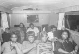 Members of Bobby Moore and the Rhythm Aces seated on the group's bus after a performance at a dance at the National Guard Armory on Dallas Avenue in Selma, Alabama.