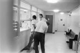 Sergeant Clifford Vasser and Lieutenant Doug Acker booking Anthony Ray Hinton on capital murder charges at the city jail in Bessemer, Alabama.