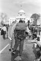 Man with a backpack in front of the Capitol in Montgomery, Alabama, at the conclusion of the Selma to Montgomery March.