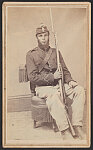 [Unidentified African American soldier in Union uniform with Empire State shield, 97, and pompom on kepi, holding bayoneted rifle]