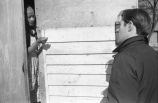 Pat Thomas talking with an elderly woman.