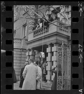 Students involved in sit-in hoist a bag up to balcony of Boston University administration building