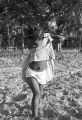 Little girl standing on a patch of dirt, close to the cotton field of Mrs. Minnie B. Guice near Mount Meigs in Montgomery County, Alabama.