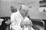 Woman kisses baby, Los Angeles, 1983