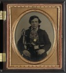 [Unidentified soldier in Confederate uniform with cavalry sword and revolver]