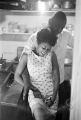 Charlie Marshall, a cook at the Laicos Club in Montgomery, Alabama, in the kitchen with a woman.