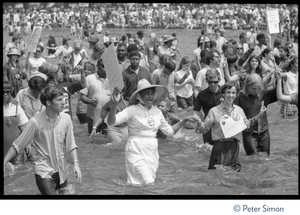 Splashing in the Reflecting Pond during the Poor Peoples’ Campaign Solidarity Day Protesters holding signs and wearing buttons with image of Martin Luther King, Jr.