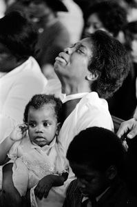 Emotional African-American mom at Easter church service in Roxbury, Boston