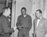 Presentation of a safety medal to an employee at Nolin Brothers Refrigeration Company in Montgomery, Alabama.