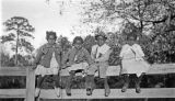 Four African American children sitting on a fence in Wilcox County, Alabama.