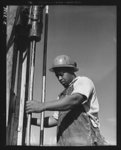 Tennessee Valley Authority. Construction of Douglas Dam.  Negro drill machine operator at TVA's new Douglas Dam on the French Broad River. This dam will be 161 feet high and 1,682 feet long, with a 31,600 acre reservoir area extending forty-three miles upstream. With a useful storage capacity of approximately 1,330,000 acre-feet this reservoir will make possible the addition of nearly 100,000 kilowatts of continuous power to the TVA system in dry years and almost 170,000 kilowatts in the average year