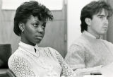 Two students listen to a lecture in the College of Business Administration