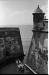 Men navigating through an opening of the fortress, Cartagena, 1975