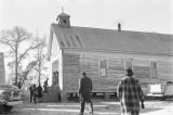 Thumbnail for People entering a wooden church building in rural Prattville, Alabama, probably for a meeting of the Autauga County Voters Association.