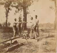 Men turning valve on irrigation line