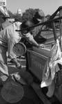 African American man buying fish from white man: Image 2