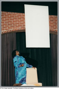 Photograph of Mzuri leaning backwards on the stage