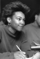 A student takes notes during a class lecture, 1989