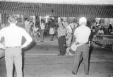 Group standing and sitting on a sidewalk in front of a store in downtown Montgomery, Alabama, during a civil rights demonstration.