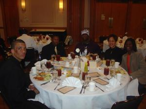 People seated around table at 2005 Black History Month