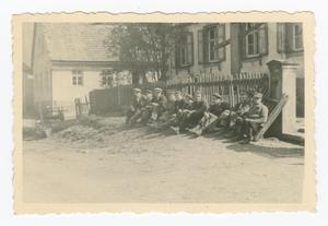 Freed Polish Slaves Sitting by a Fence