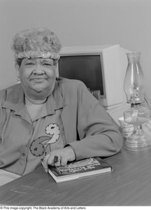 Clara Miles seated at her work desk