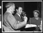 Charlotta Bass gets ready to light a candle on a cake during the second anniversary celebration for the Independent Progressive Party of California, circa 1950, Los Angeles