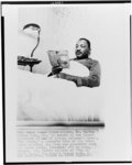 [Dr. Martin Luther King, Jr., lying in bed reading the novel "The Prize" by Irving Wallace, Oslo, Norway]