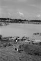 Children on a hill leading to the bank of "The Big Ditch," a gravel quarry filled with water near Newtown, a neighborhood in Montgomery, Alabama.