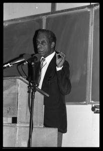 James Baldwin lecturing at UMass Amherst Baldwin standing at a podium with microphones