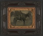 Thumbnail for [Unidentified soldier in Union first lieutenant's uniform and kepi with cavalry saber atop horse in front of fence, building, and woods]