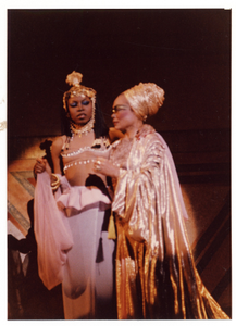 Performance picture of Eartha Kitt (in a gold turban) and a woman]. [color photoprint